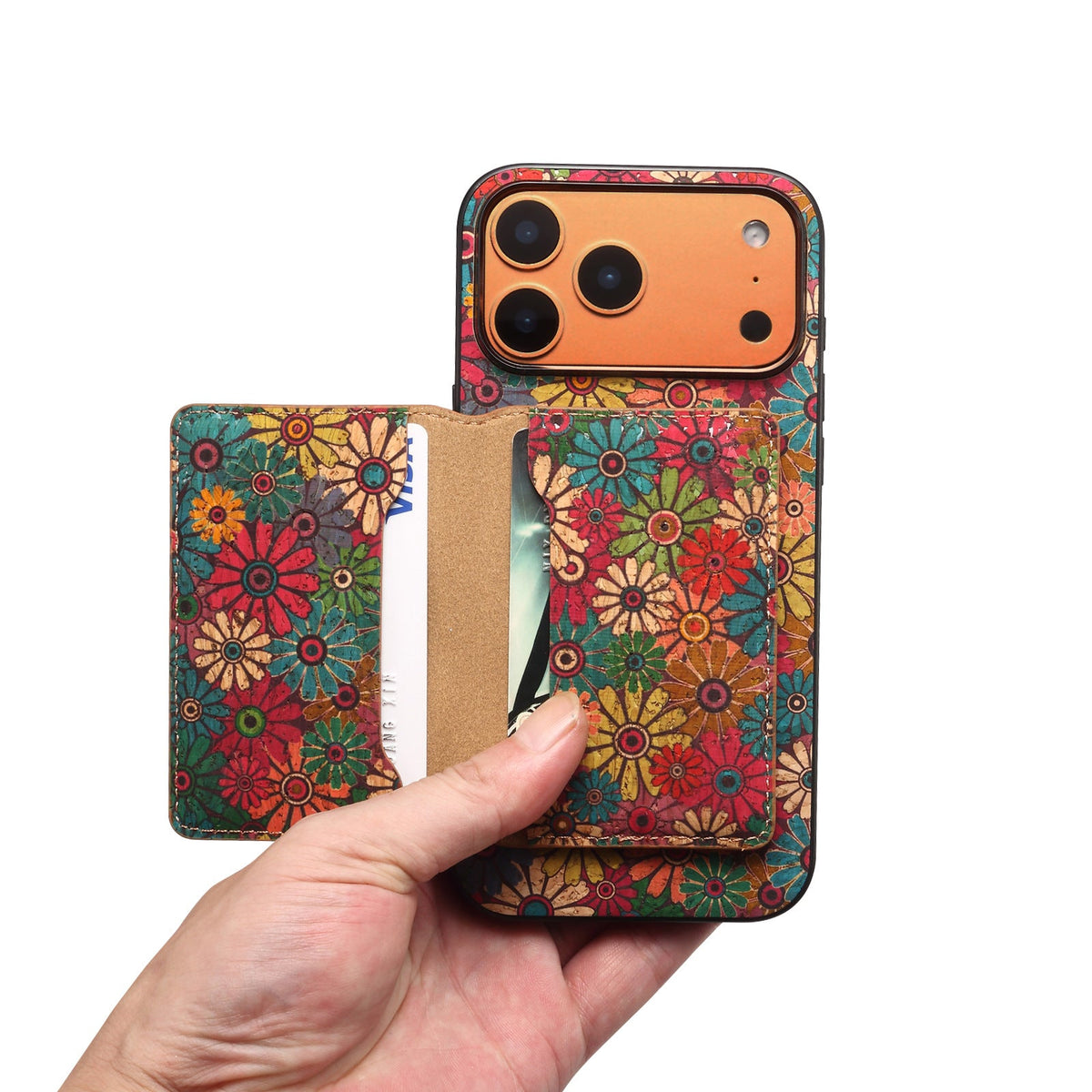 Hand sliding a card out of the floral magnetic wallet on the back of the case