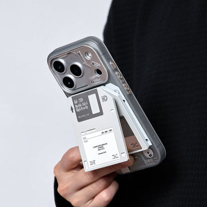 Floppy disk stand being attached to the back of an iPhone