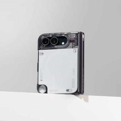 iPhone Duo in the gloss see-through case standing against a gray wall