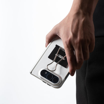 Hand carrying an iPhone Duo in the Silver case, camera at the bottom