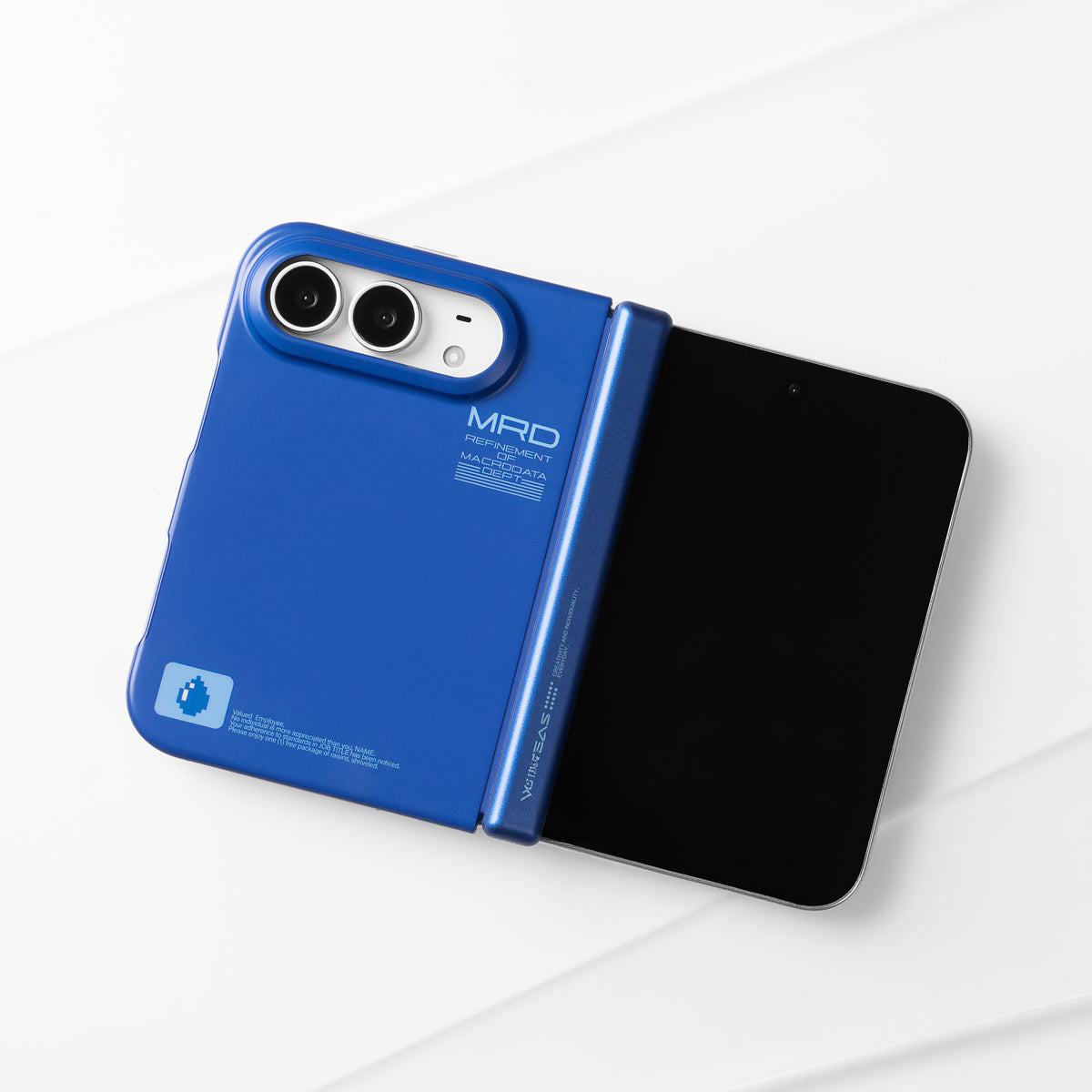 Unfolded iPhone Duo in the matte blue case lying on a white surface