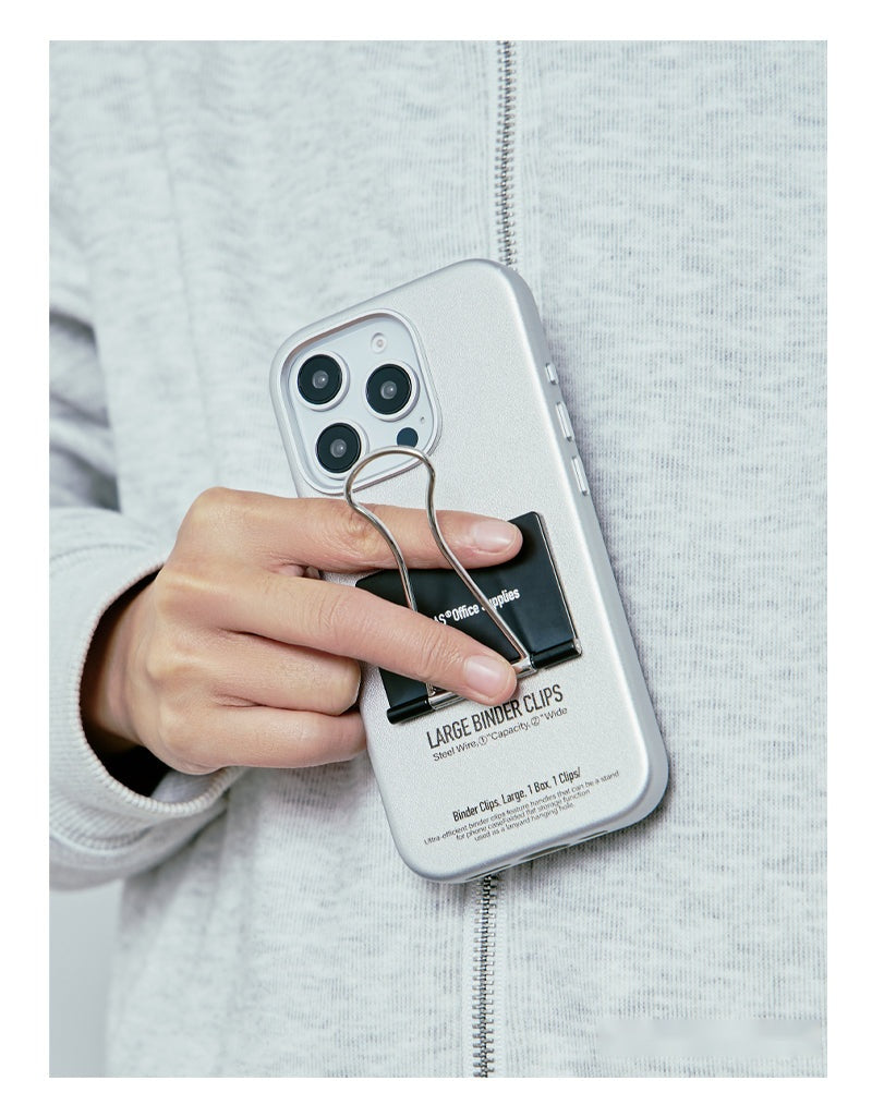 Hand reaching into the binder clip on the back of the case