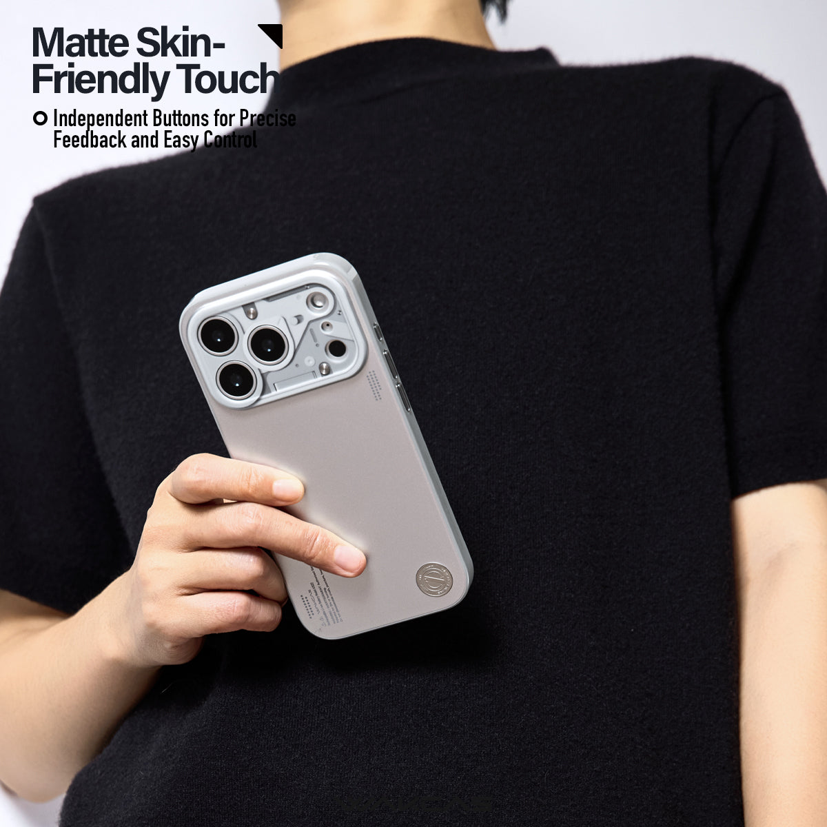Person in a black top holding the chrome silver case