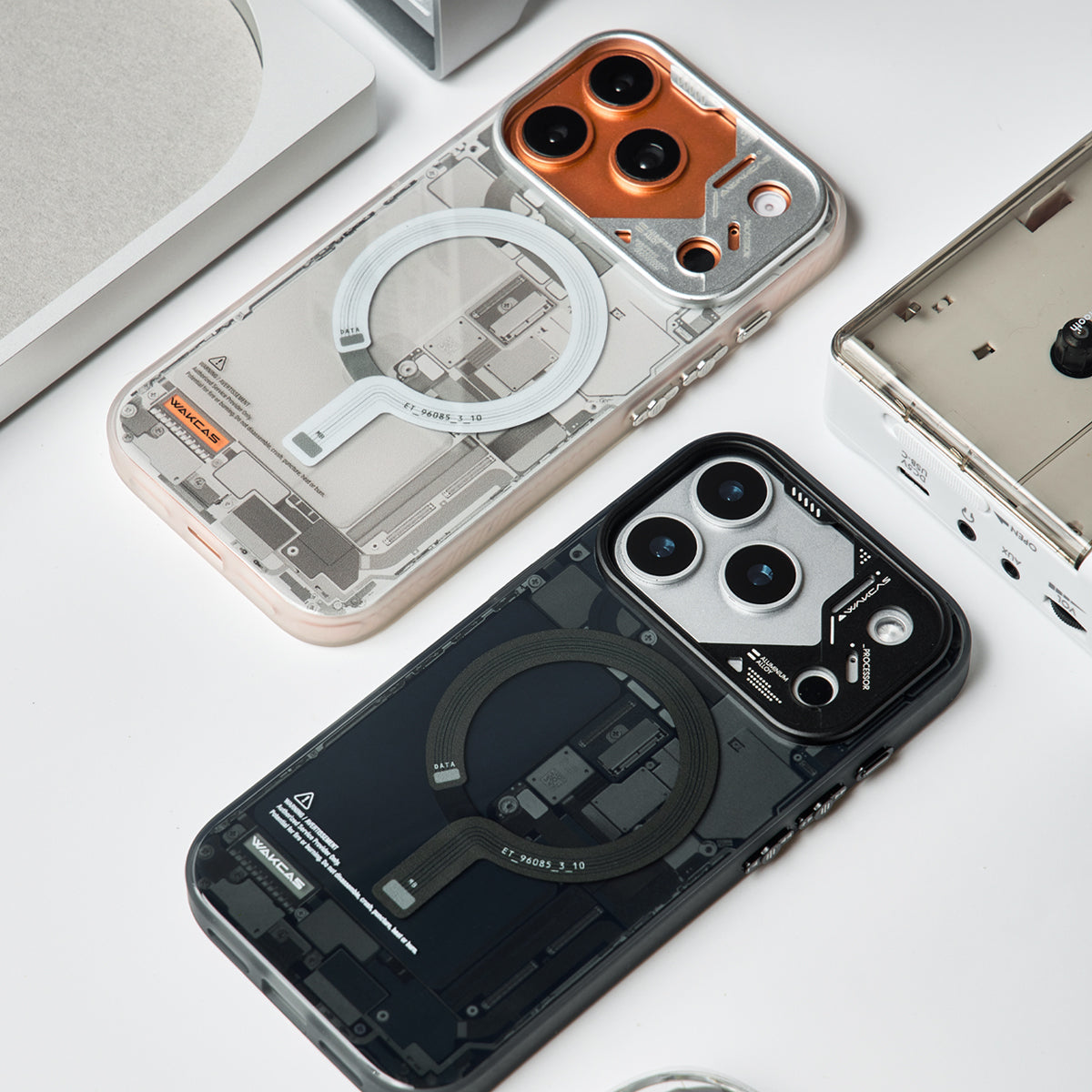 Grey and black circuit board cases lying on a white desk