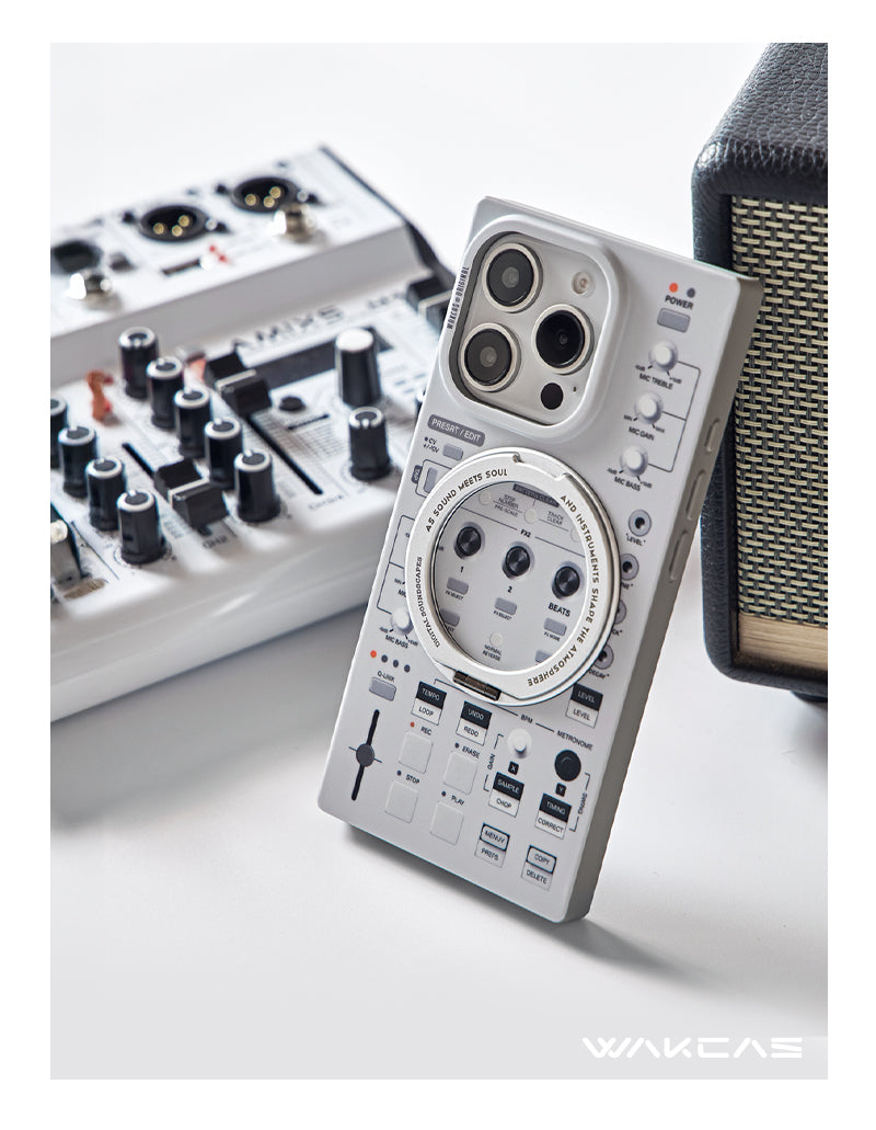 Gray music sampler case beside a small audio mixer