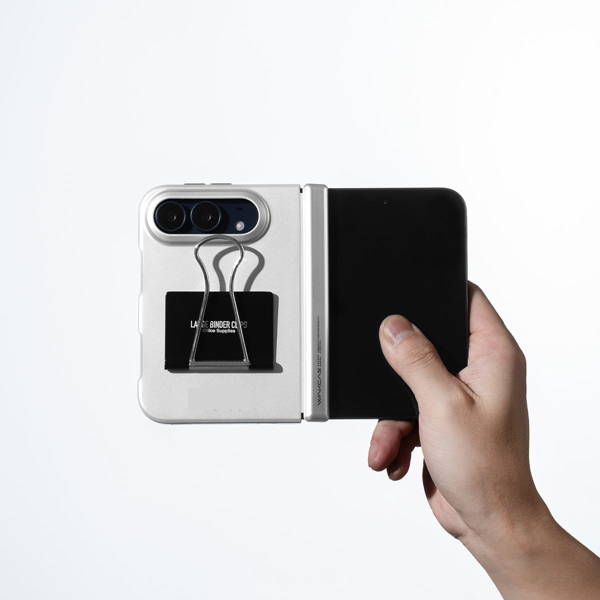 Unfolded iPhone Duo in the Silver file folder case held in one hand