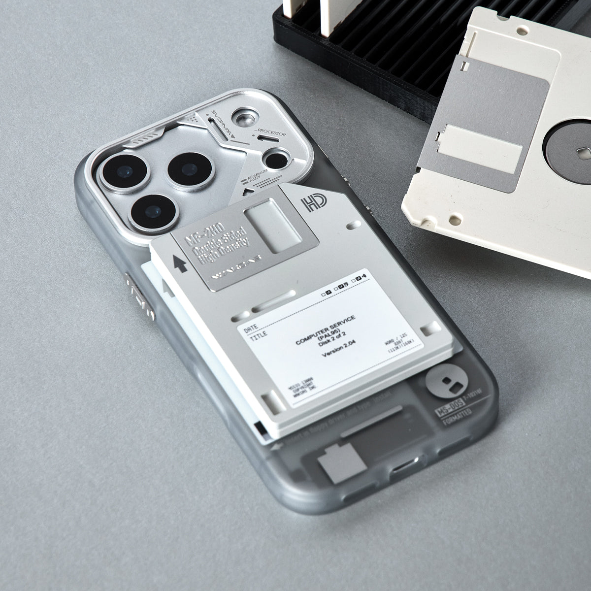Floppy disk stand attached flat to the back of an iPhone in a gray case