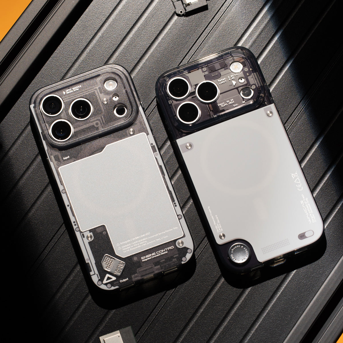 Two gloss see-through iPhone cases laid flat on a textured surface