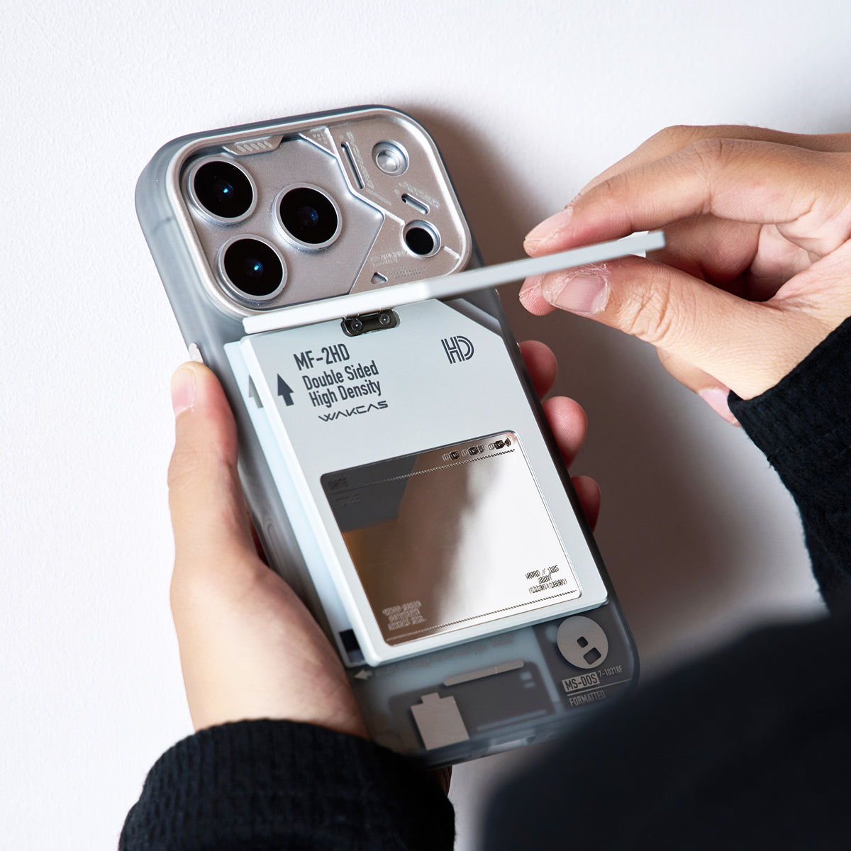 Writing on the label area of the floppy disk stand attached to an iPhone