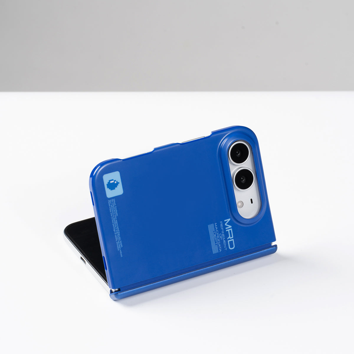 Matte blue iPhone Duo case partially folded and standing on a table