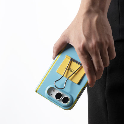 Hand holding the Blue case upside down with the binder clip visible