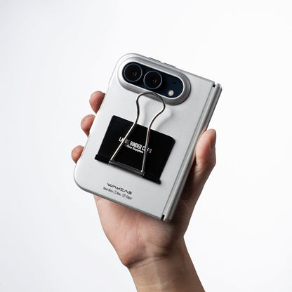 Hand holding an iPhone Duo in the Silver case showing the black label and clip