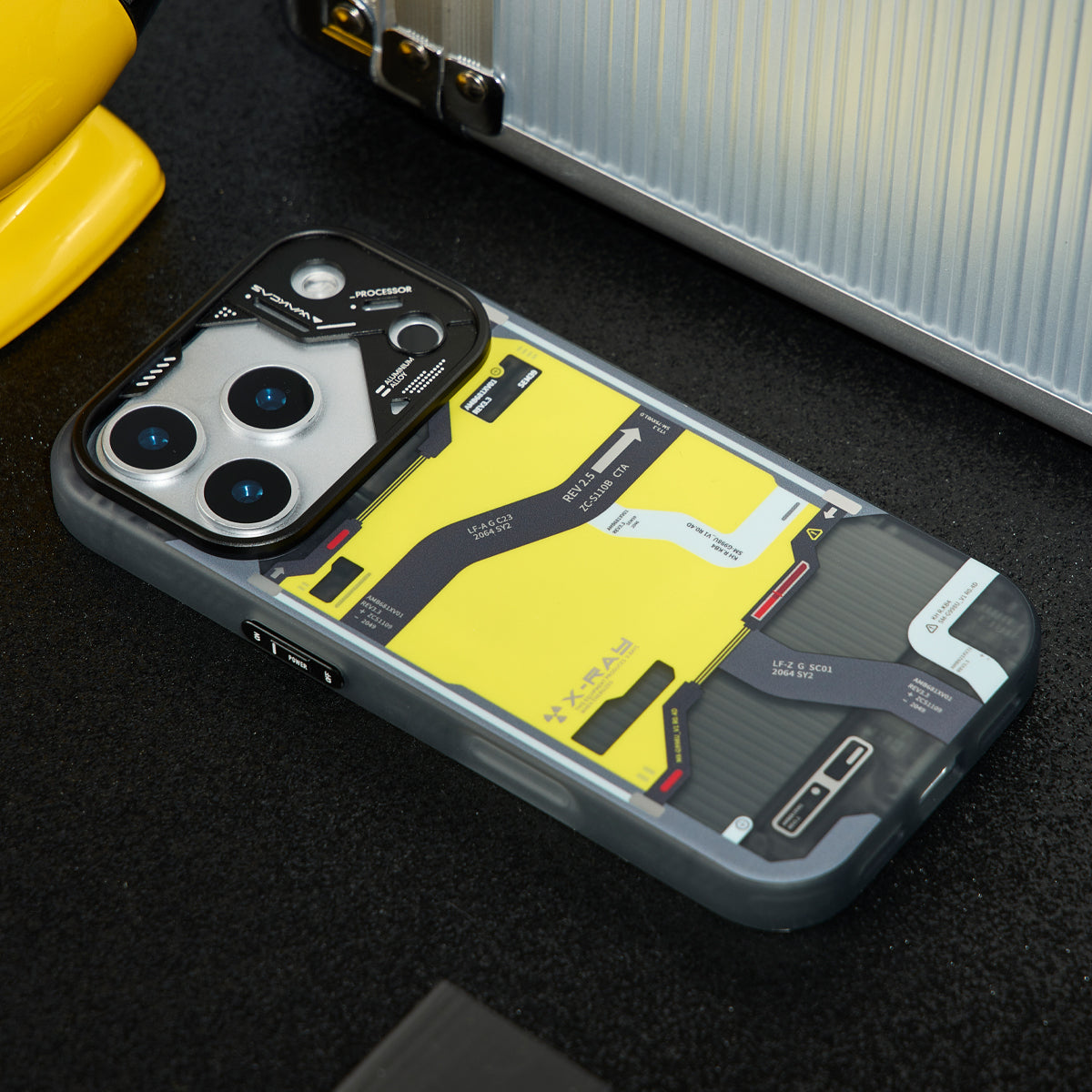 Tactical map case lying on a dark surface next to a metal toolbox