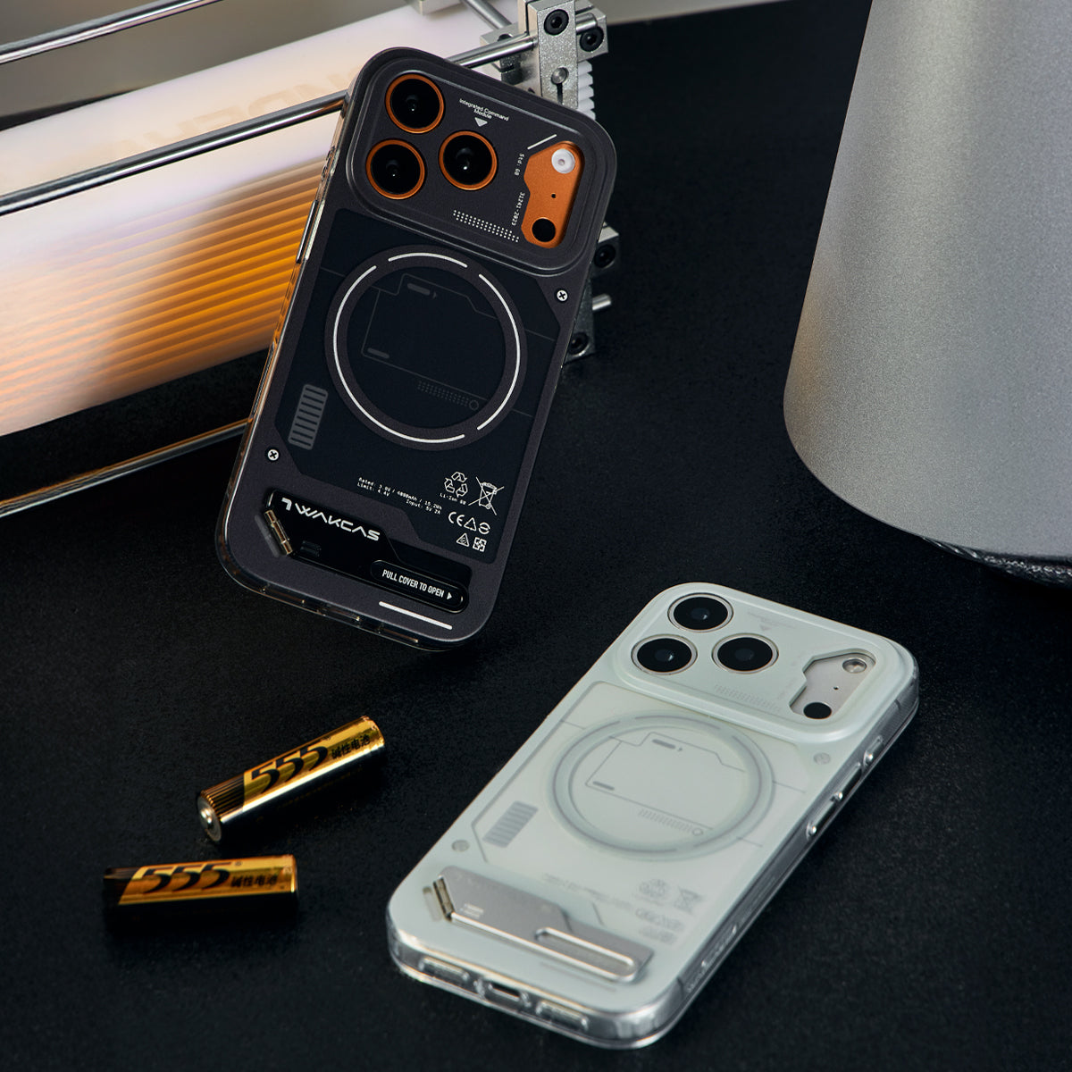 Black and grey battery module cases on a desk