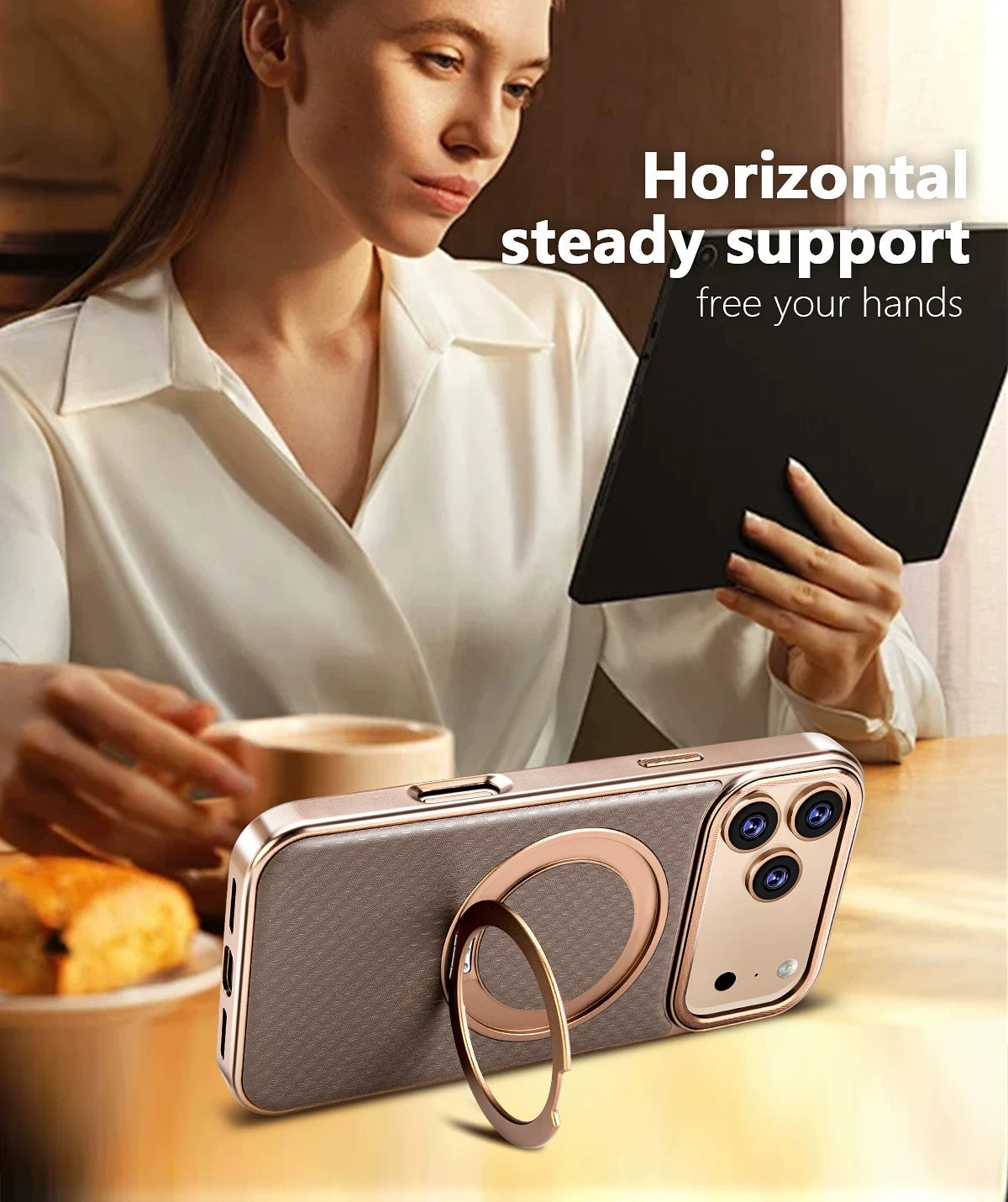 Phone in a brown case standing in landscape on its ring stand beside a woman reading