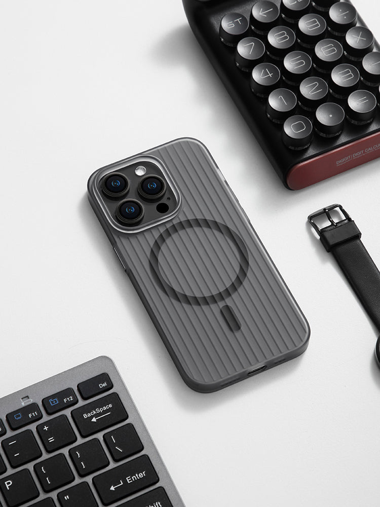Black striped MagSafe iPhone case on a desk next to a keyboard