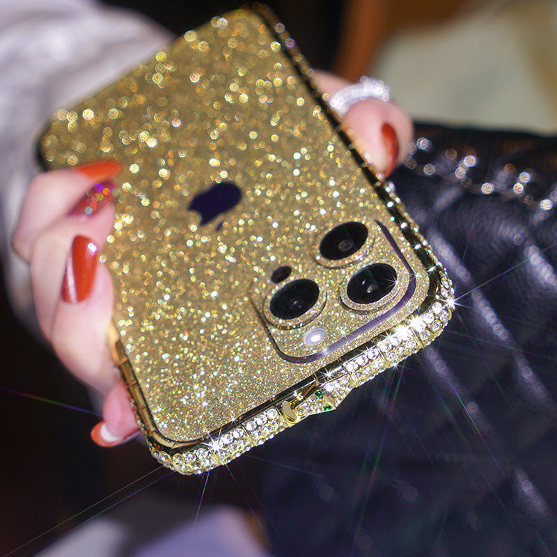 Gold glitter iPhone case with rhinestone bumper, angled to catch the light