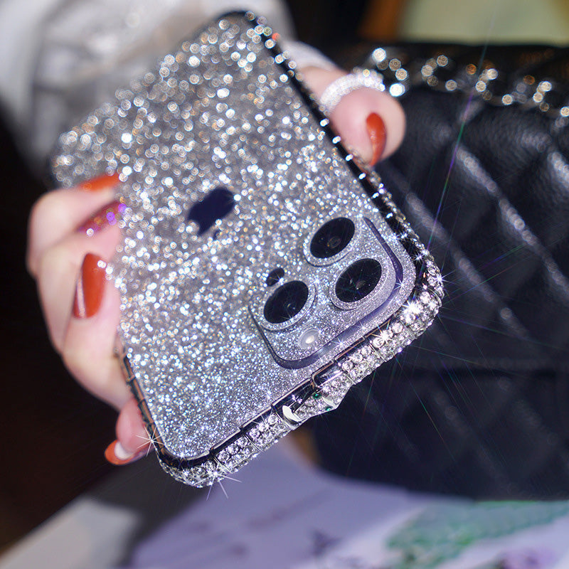 Silver glitter iPhone case with rhinestone-lined edge and sparkling camera lens rings