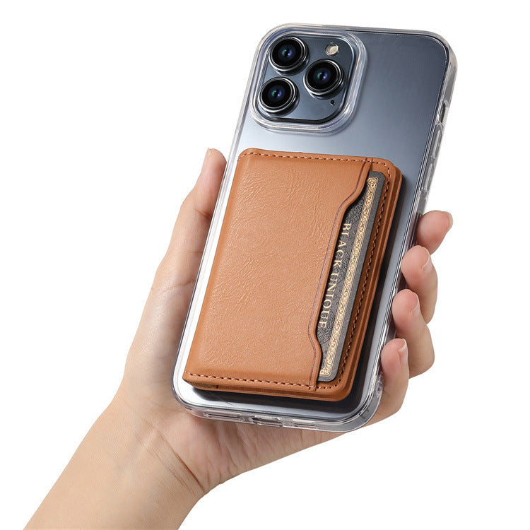 Hand holding an iPhone in a clear case with the tan magnetic wallet attached