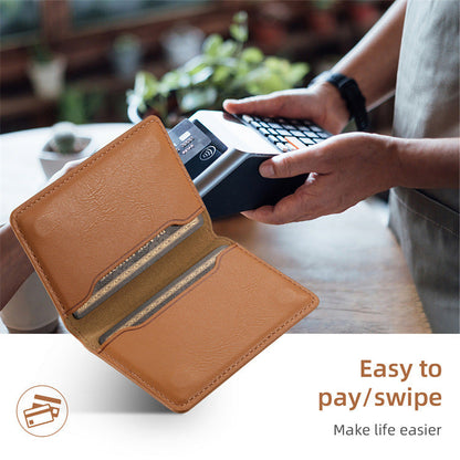 Open tan card holder wallet showing a card in the inner pocket