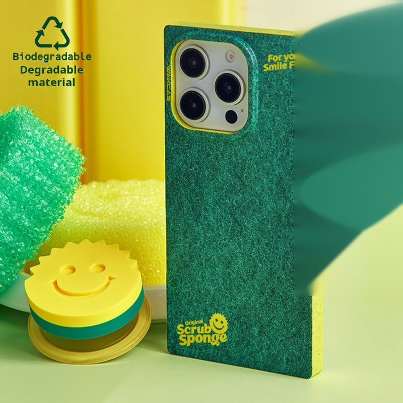 Sponge-print case styled next to green sponges and the smiley magnetic stand