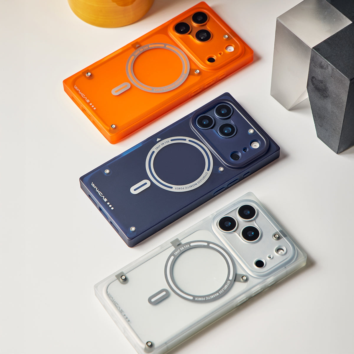 Orange, blue and white square iPhone cases laid out on a table