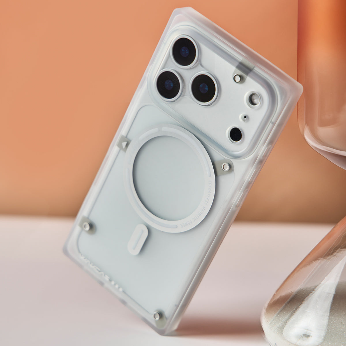 Transparent white square iPhone case leaning on a glass block