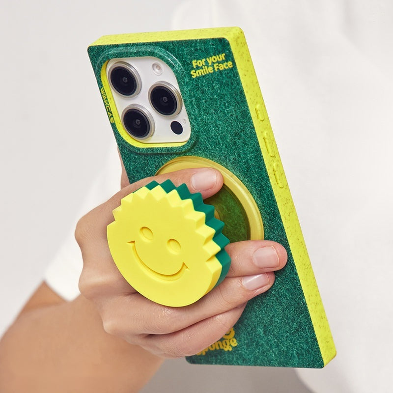 Hand holding the sponge-print iPhone case with the smiley magnetic stand attached