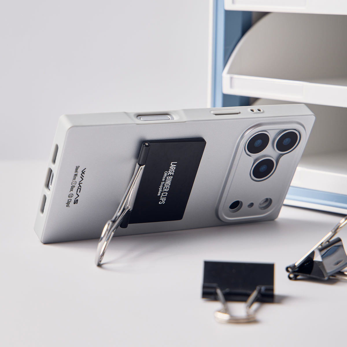 Silver case propped up on its binder clip kickstand