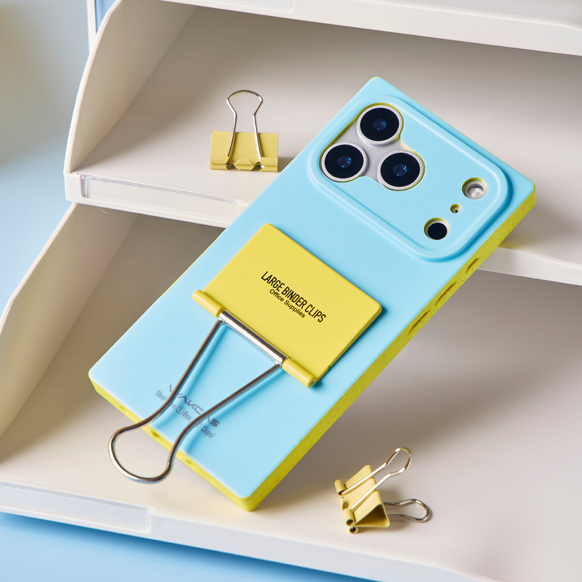 Light blue case lying on a shelf with the clip handle out